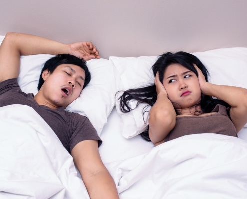 man snoring and girlfriend annoyed