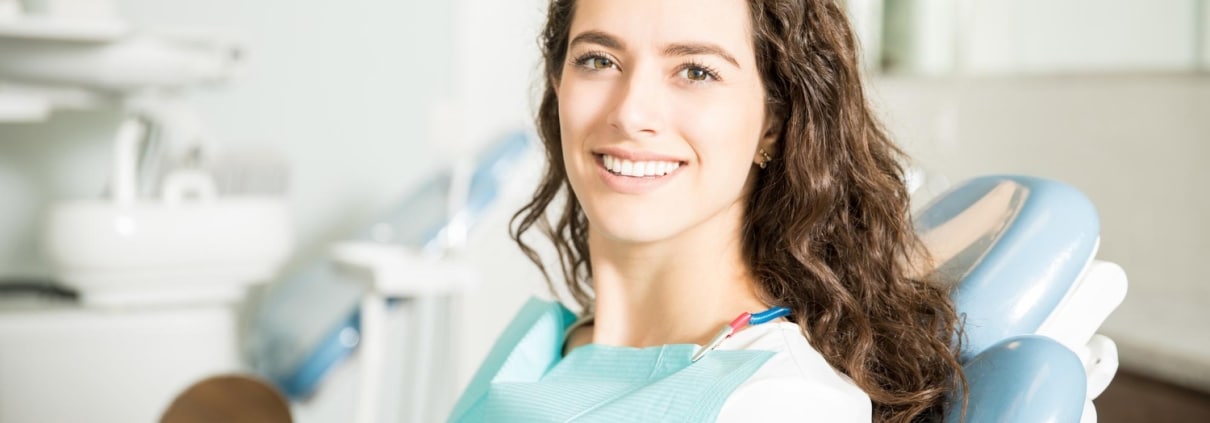 Young woman smiling at the dentist