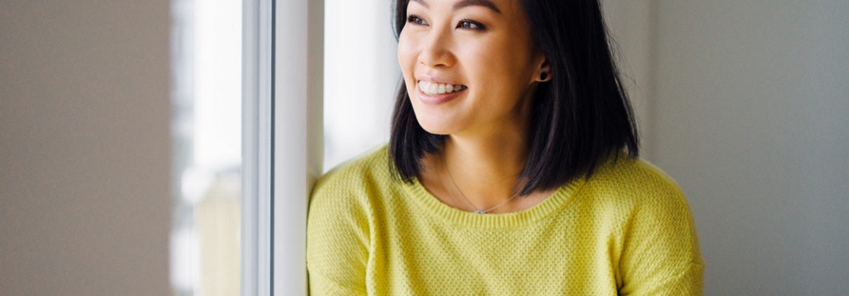 Young woman smiling with orthodontic treatment