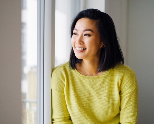 Young woman smiling with orthodontic treatment