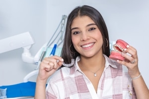 Young woman showing Invisalign and braces