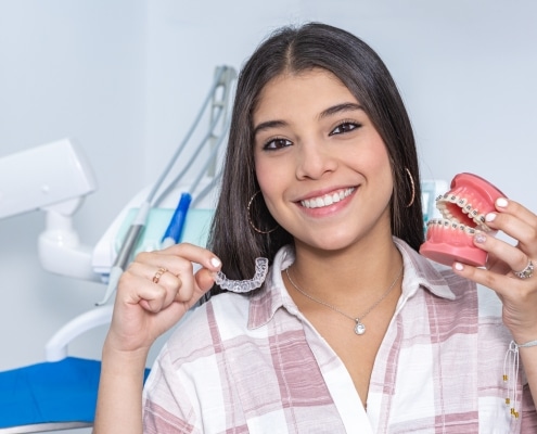 Young woman showing Invisalign and braces