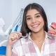 Young woman showing Invisalign and braces