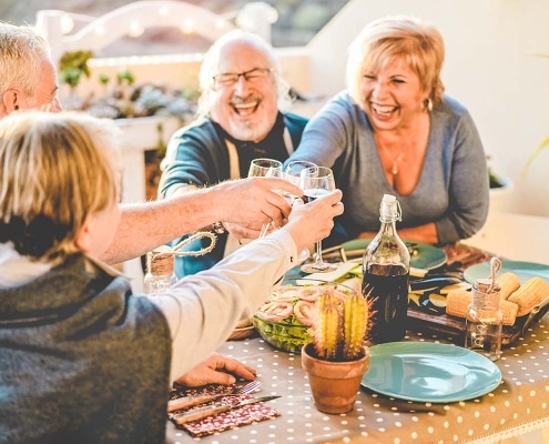 group of friends having dinner outside; giving a toast