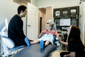 Dr. Desai and a dental hygienist with a young patient