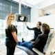 patient getting consulted about their dental X-ray by Dr. Nathan Desai and a dental assistant
