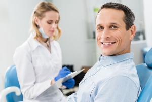 dentist consulting a patient who's sitting in the dental chair