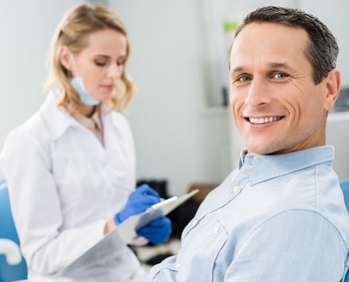 dentist consulting a patient who's sitting in the dental chair